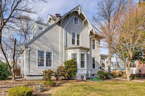 A large, two-story house with a prominent bay window and a wrap-around porch. - Explore Orange & Nyc! Luxury Family Home w/ Deck (Orange)