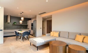 A modern living space with a dining area, a sofa, and a coffee table. - Sissi Lux Kappa Villa Private Pool (Sisi)