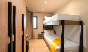 A bunk bed room with a wooden wardrobe, a nightstand, and a window with curtains. - Sissi Lux Kappa Villa Private Pool (Sisi)