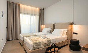 A hotel room with two beds, a large window with curtains, a bedside table, and a chair. - Sissi Lux Kappa Villa Private Pool (Sisi)