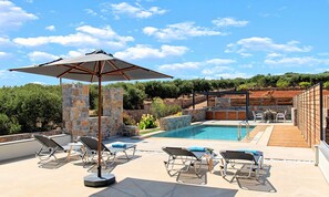 A poolside area with lounge chairs, a table, and a pergola with an umbrella. - Sissi Lux Triplex Villa Private Pools 36 Guests (Sisi)