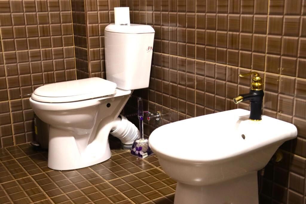 Un baño con inodoro, bidé y lavabo.