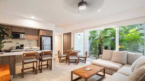 A modern living space with a kitchen, dining area, and seating area. - Bright 2BR Condo | Aldea Zama (Tulum)