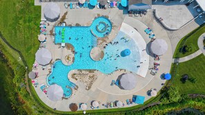 An aerial view of a swimming pool complex with multiple pools, sun loungers, and umbrellas. - Coastal Serenity! 5 Bedroom Home in Millville by the Sea Community. Steps away from the Community Pool, Shuttle to the Beach, Free WIFI and more! (Millville)