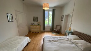 A bedroom with two single beds, a dresser, a chair, and a window with curtains. - The Oasis Gardens, Beautiful House (Barry-d'Islemade)