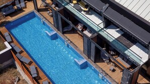 A rooftop pool with multiple levels of seating and a glass balustrade. - Private Wellness Residence with Heated Pool (Antalya)