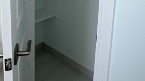 A closed closet with white walls and a metal rod for hanging clothes. - One bedroom and one washroom (Oakville)