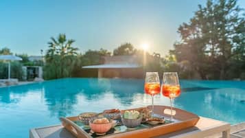 Seasonal outdoor pool, open 9:00 AM to 8:00 PM, pool umbrellas