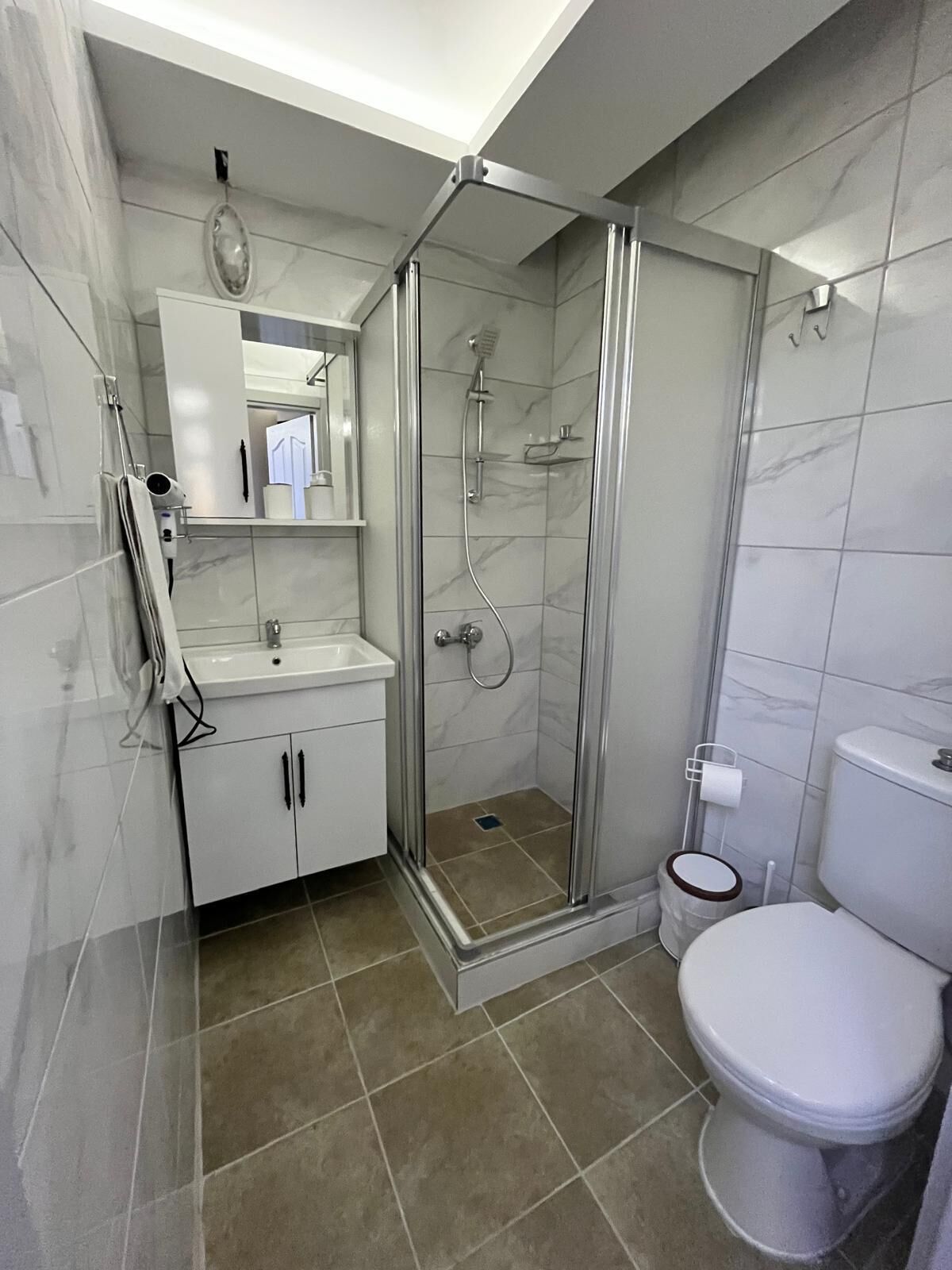 Separate bathtub and shower, hair dryer, towels, soap