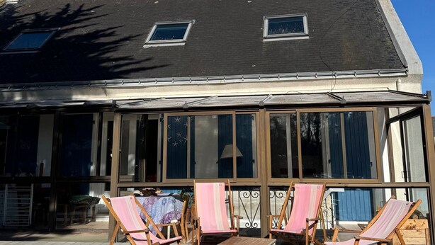 A house with a large glass front, wooden deck, and two windows. - Family home in Belle-Ile-En-Mer (Le Palais)