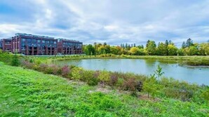 A modern building with a rectangular shape, large windows, and a flat roof. - Quiet charming townhome condo (Whitchurch-Stouffville)
