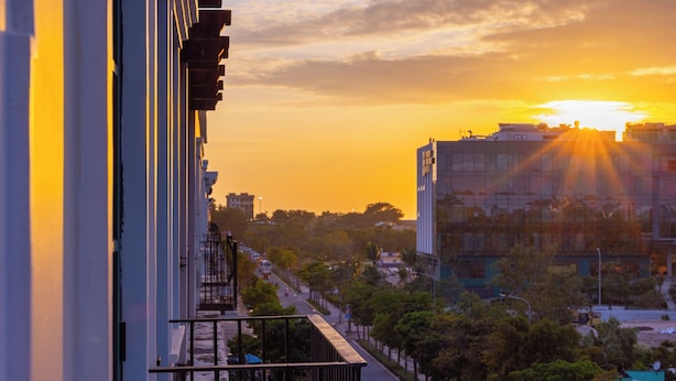 A cityscape at sunset with buildings and a clear sky. - CIEL ROSE HOTEL (Phu Quoc)