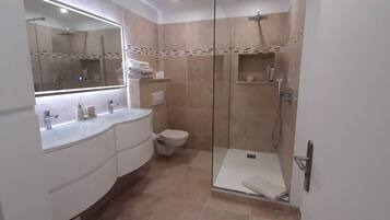 Shower, hair dryer, towels, toilet paper
