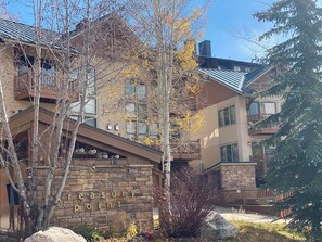 A multi-story building with a stone facade and a sign reading "Crescent Point." - Bring your family and enjoy a 3-bedroom condo in charming Crested Butte (Crested Butte)