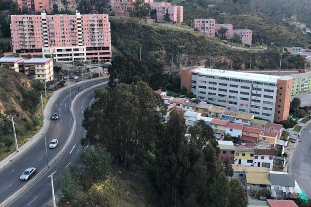 A multi-story building with a curved road in front.