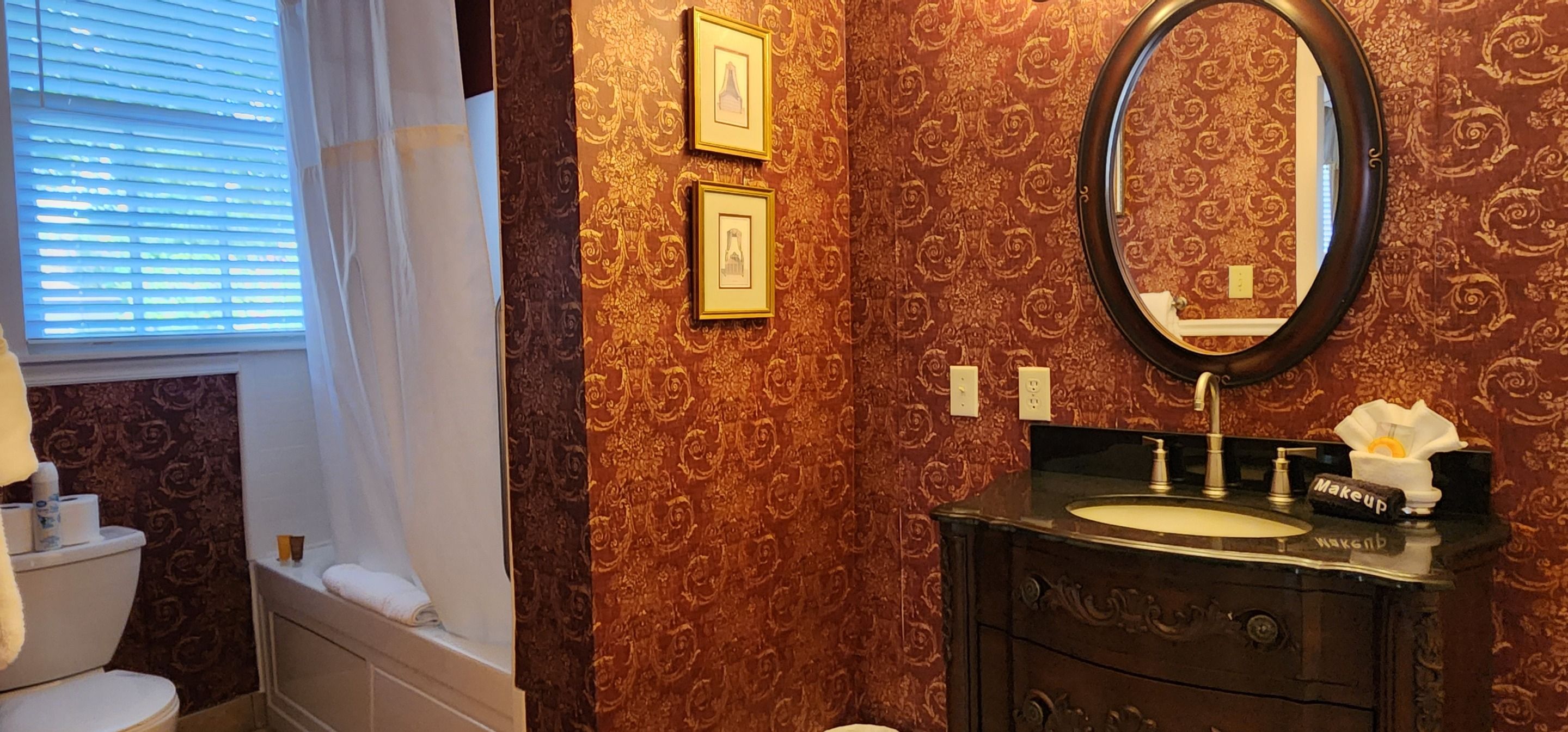A bathroom with a vanity, a mirror, and a toilet.