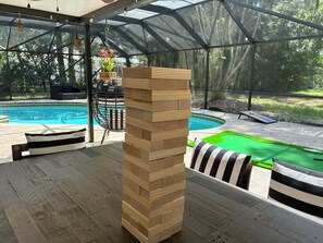 A covered outdoor area with a wooden block tower, a pool, and a green artificial turf area. - 6 Bedroom Pool property. Pet Friendly (Melbourne)