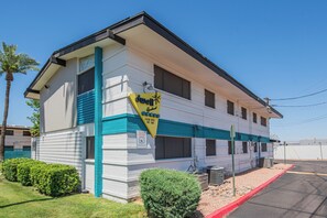 A two-story motel with a white exterior and teal trim. - Dwell 1723-1 (Scottsdale)