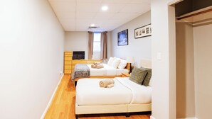 A hotel room with two beds, a TV, a desk, and a window with curtains. - Boston Getaway, Close to Airport (Boston)