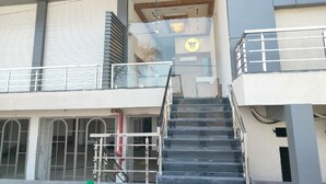 A multi-story building with a staircase leading to an upper level. - Heaven X Inn Hotel (Indore)