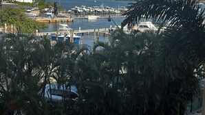 A marina with boats docked, surrounded by buildings and palm trees. - Water View with Balcony- newly renovated Contemporary style (Lantana)