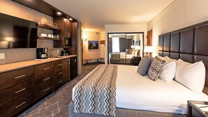 A hotel room with a large bed, a separate sitting area with a view, a kitchenette, and a bathroom. - Snowbird Cliff Lodge Resort Studio 1BR+/1B...Ski-In/Ski-Out, Full Resort Access (Sandy)