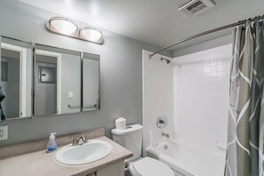 A bathroom with a sink, toilet, and shower. - Dwell 1911-3 (Scottsdale)