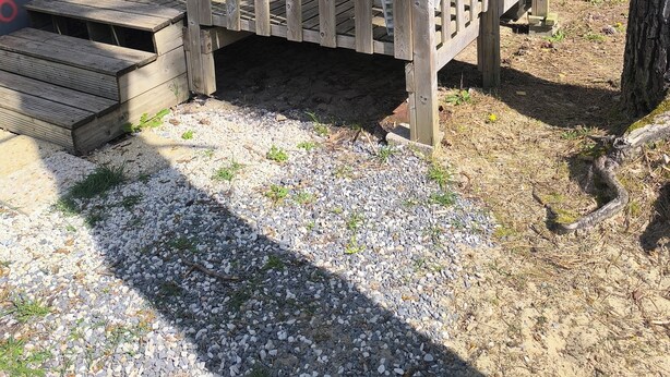 A mobile home with a wooden deck and a covered porch. - Place of Peace, (Camiers)