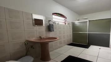 Chuveiro, toalhas de banho, papel higiênico