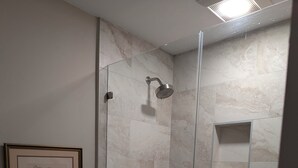 A bathroom with a glass-enclosed shower, a toilet, and a framed picture on the wall. - Beach/Pool Access-Location Location Location! (Hilton Head Island)