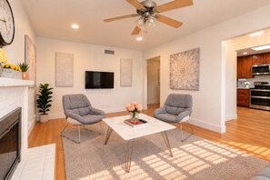 Bright, cozy living room with fireplace, TV, and open kitchen access - 3BR Home Ideal for Work Trips, Family & Long Stays (Fremont)