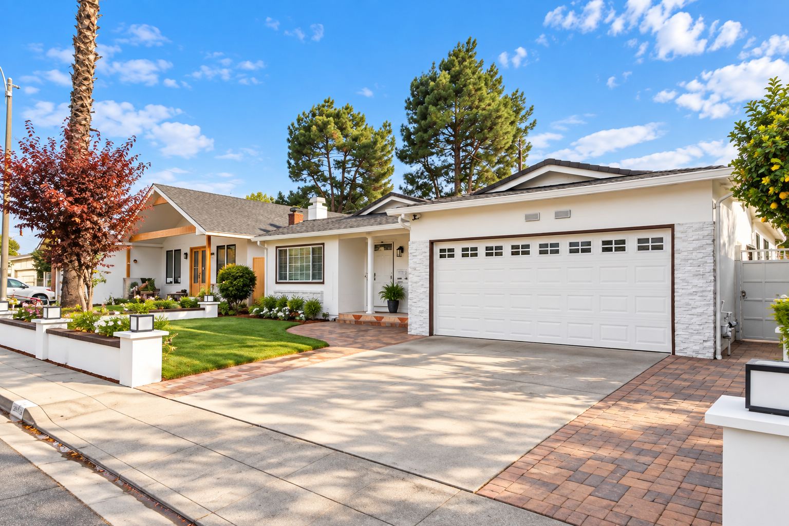 A residential house with a garage, a driveway, and a well-maintained lawn.