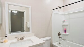 A bathroom with a sink, toilet, and bathtub. - The One 216 (Glendale)