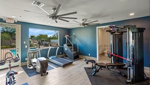 A home gym with exercise equipment, a treadmill, a stationary bike, and a weight machine. - The One 311 (Glendale)