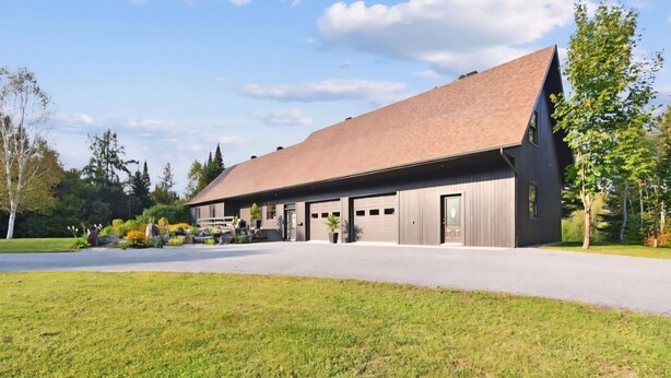 A modern building with a large garage and a covered driveway.