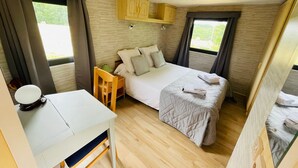 A compact bedroom with a bed, bedside table, and a small desk. - A little corner of paradise (Église-Neuve-de-Vergt)