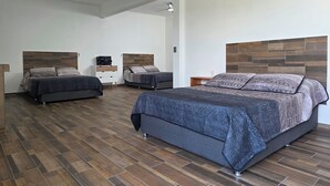 A spacious bedroom with two beds, a ceiling fan, and a modern design. - Weekend or vacation home, with pool and large garden. (Tlayecac)