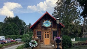 A rustic log cabin with a sign for 'Roscoe Outfitters' and 'Campground Park'. - Welcome Families and Friends to the Home of Laughter and More Laughter (Livingston Manor)