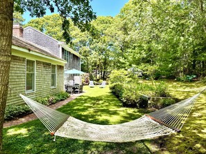 A house with a backyard, a hammock, and a dining area. - South Orleans Getaway (Orleans)