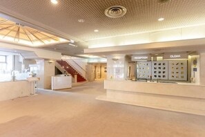 A spacious lobby with a reception desk, a staircase, and a cloakroom. - Choshi Plaza Hotel (Choshi)