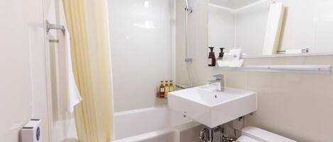 A modern bathroom with a bathtub, a sink, and a shower.