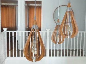 Two pendant lights with wooden shades hanging from a white railing. - "Sundaze" - Luxury Holiday Home (Catherine Hill Bay)