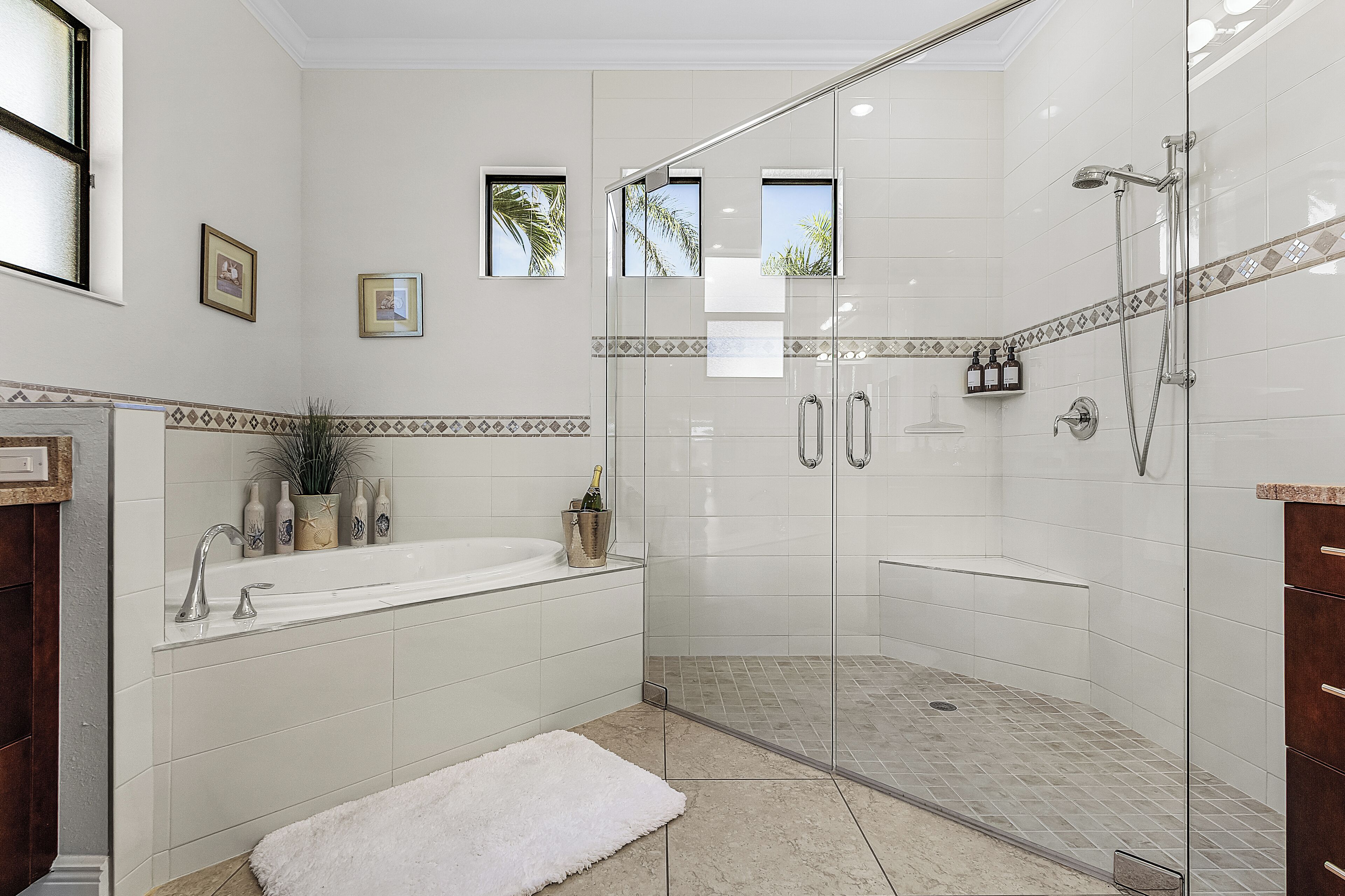 Ein modernes Badezimmer mit einer gläsernen Duschkabine, einer freistehenden Badewanne und einem Waschtisch.