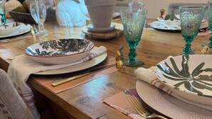 A dining table set with plates, glasses, and a small potted plant. - Downtown gem B&B, 2 ml from Buffalo Trace on Bourbon Trail (Frankfort)