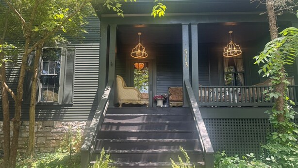 A porch with two chandeliers, a set of stairs leading up to a door, and a bench with a potted plant beside it. - Downtown gem B&B, 2 ml from Buffalo Trace on Bourbon Trail (Frankfort)
