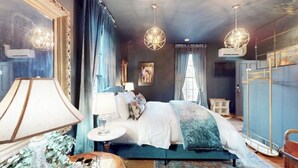 A bedroom with a large bed, a round table, and a mirror. - Downtown gem B&B, 2 ml from Buffalo Trace on Bourbon Trail (Frankfort)