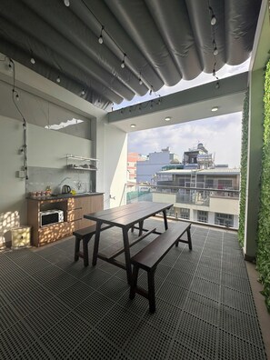 Deluxe Quadruple Room, Balcony, City View | Outdoor dining - AP Home (Tan Binh)