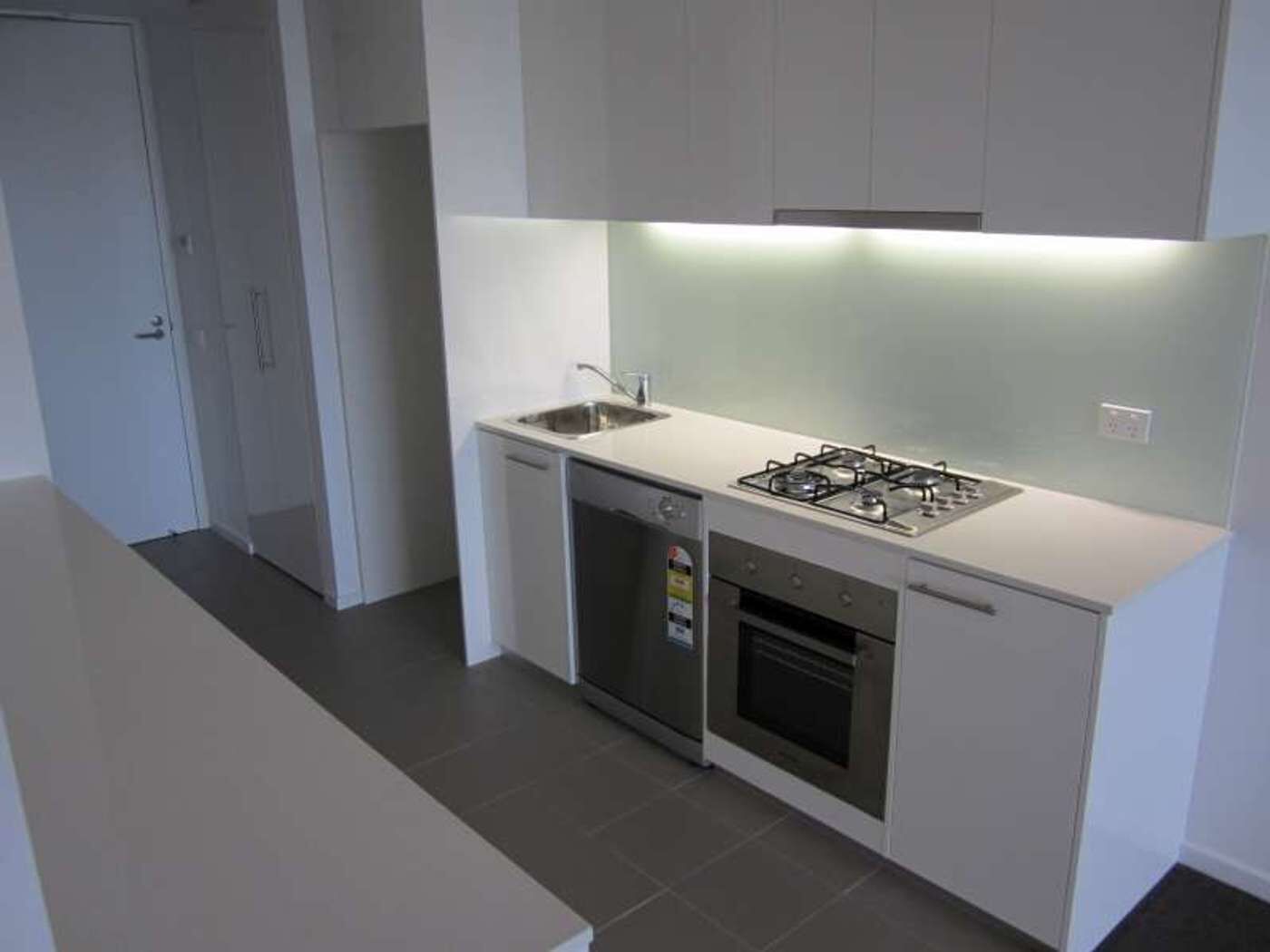A modern kitchen with a gas stove, dishwasher, and oven.