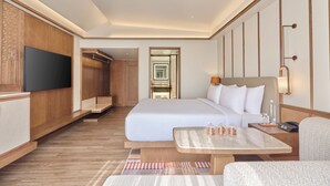 A hotel room with a large bed, a TV, a desk, and a mirror. - Slohh by Roach Bengaluru, Curio Collection by Hilton (Bengaluru)