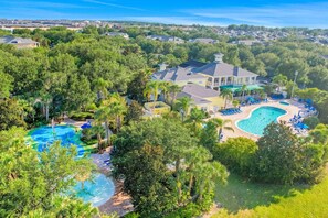 A residential area with multiple houses, a large swimming pool, and lush greenery. - Exclusive lakeview condo, sleeps 8 (Davenport)